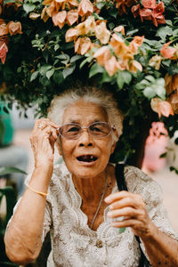 Portrait of woman with arms raised