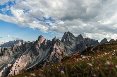 Scenic view of mountains against cloudy sky