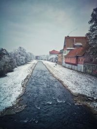 Snow covered road against sky