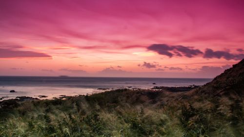 Scenic view of sea against romantic sky at sunset