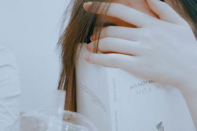 Close-up of a woman holding book