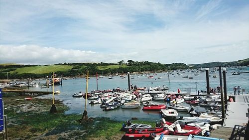 High angle view of boats moored at harbor against sky