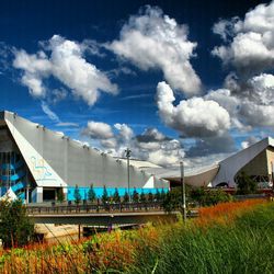 Built structure on field against cloudy sky