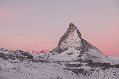 Scenic view of pink mountain against sky during sunset