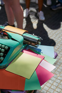 Top view of an antique metal typewriter with blank colored paper.