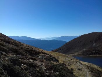 Scenic view of mountains against clear blue sky