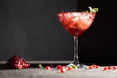 Close-up of wine glass against black background