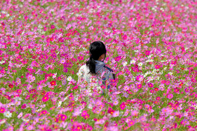 Side view of woman standing on field