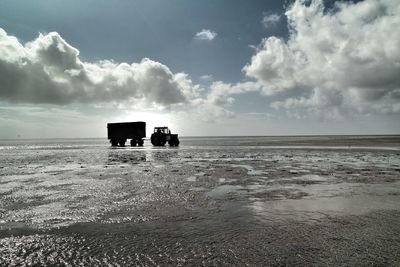 Scenic view of sea against cloudy sky