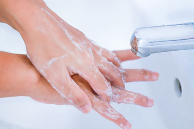 Midsection of woman with hand in water