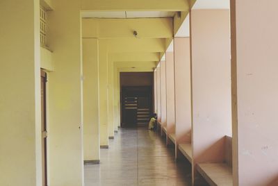 Two people on tiled floor in corridor