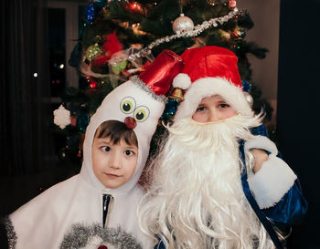 Portrait of happy girl with christmas tree