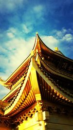 Low angle view of temple against cloudy sky