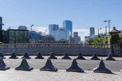 Modern buildings in city against blue sky