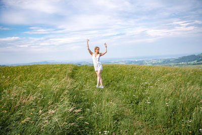 Full length of person standing on field against sky