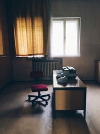 Electric lamp on table by window at home