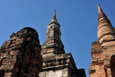 Low angle view of historical building against clear blue sky