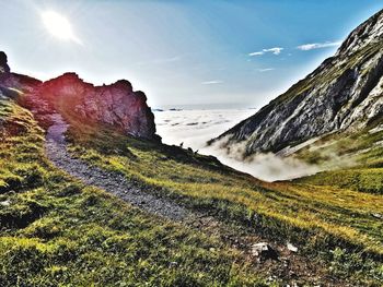 Scenic view of landscape against bright sun