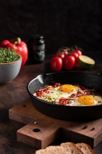 Israel traditional food shakshouka with micro greens in a cast-iron pan