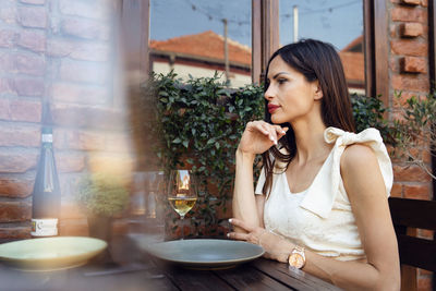 Young woman sitting on table