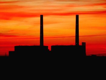 Silhouette of built structure at sunset