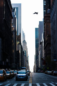 City street and buildings against sky