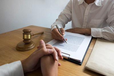 High angle view of man reading book on table