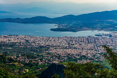 High angle view of townscape by sea against sky