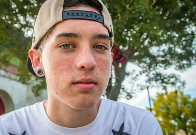 Close-up portrait of teenage boy wearing cap