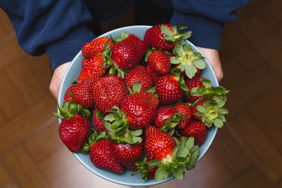 Close-up of hand holding strawberries