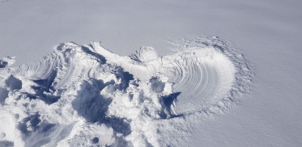 High angle view of snow covered land against sky