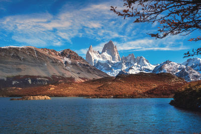 Scenic view of mountains and sea against cloudy sky