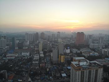 High angle view of buildings against sky during sunset