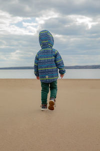 Rear view of boy on beach