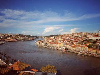 High angle view of river by buildings against sky