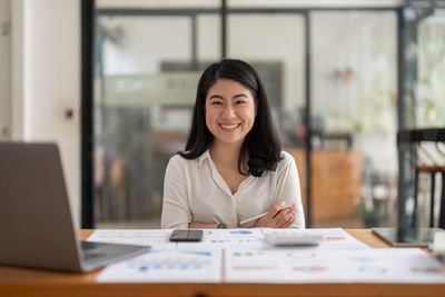 Young businesswoman working at desk in office