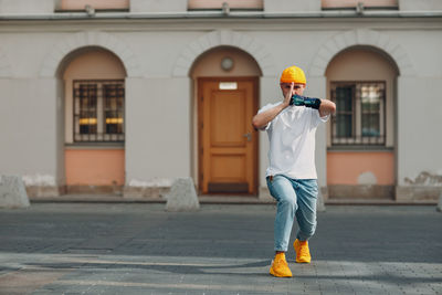 Rear view of man standing outside building