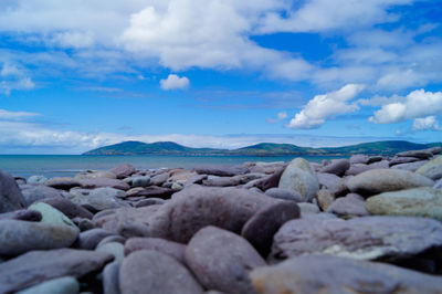 Rocks on beach against sky