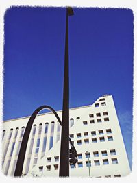 Low angle view of building against clear blue sky