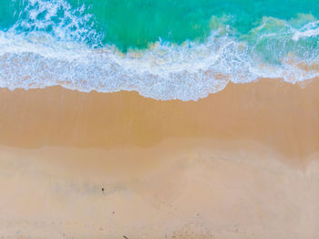 High angle view of waves rushing towards shore