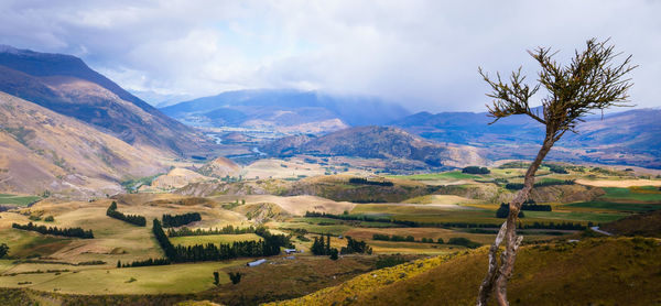 Scenic view of landscape and mountains against sky