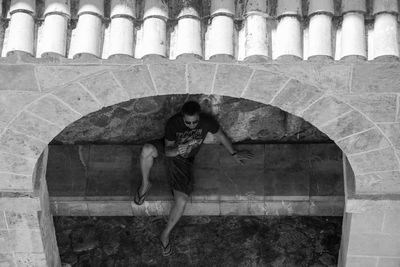 Young woman standing in front of built structure