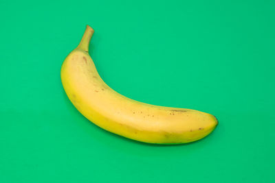 High angle view of yellow fruit against green background