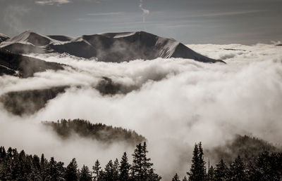 View of the belledonne massif in isère with clouds in the valley under the village of chamrousse