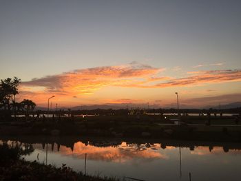 Scenic view of lake against orange sky