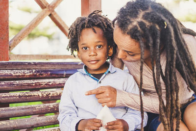 Portrait of mother and son sitting outdoors