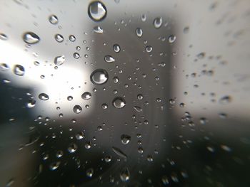 Full frame shot of raindrops on wet glass