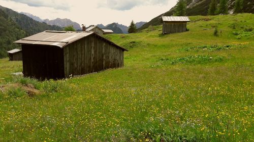 Built structure on field against sky