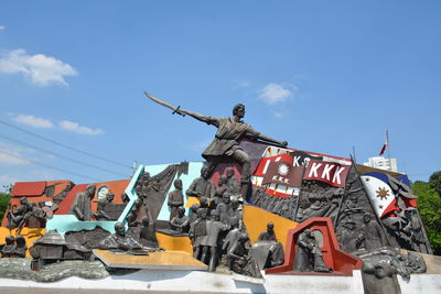 Low angle view of statue against sky