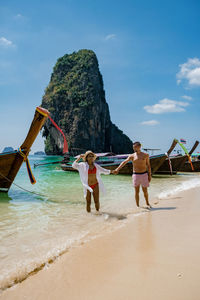 People on beach against sky